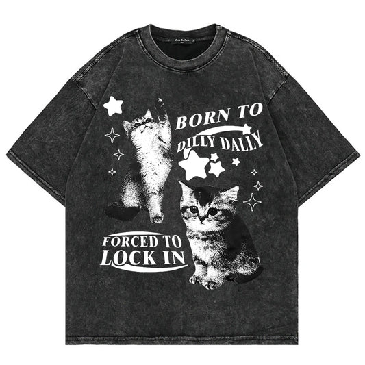 Acid‑wash black tee with two chaotic‑cute cats and ‘Born to Dilly Dally, Forced to Lock In’ graphic — alt aesthetic gremlin gift