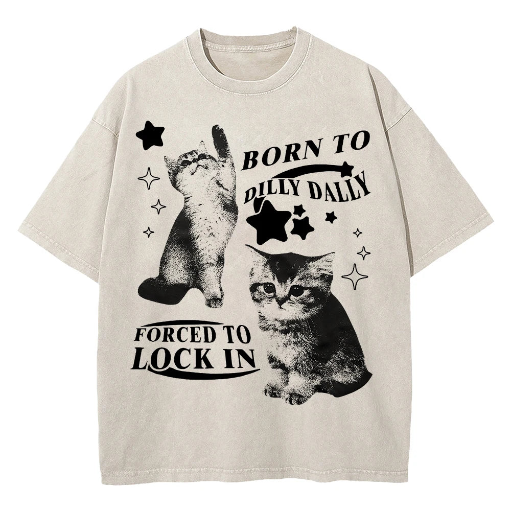 Acid‑wash cream tee with two chaotic‑cute cats and ‘Born to Dilly Dally, Forced to Lock In’ graphic — alt aesthetic gremlin gift